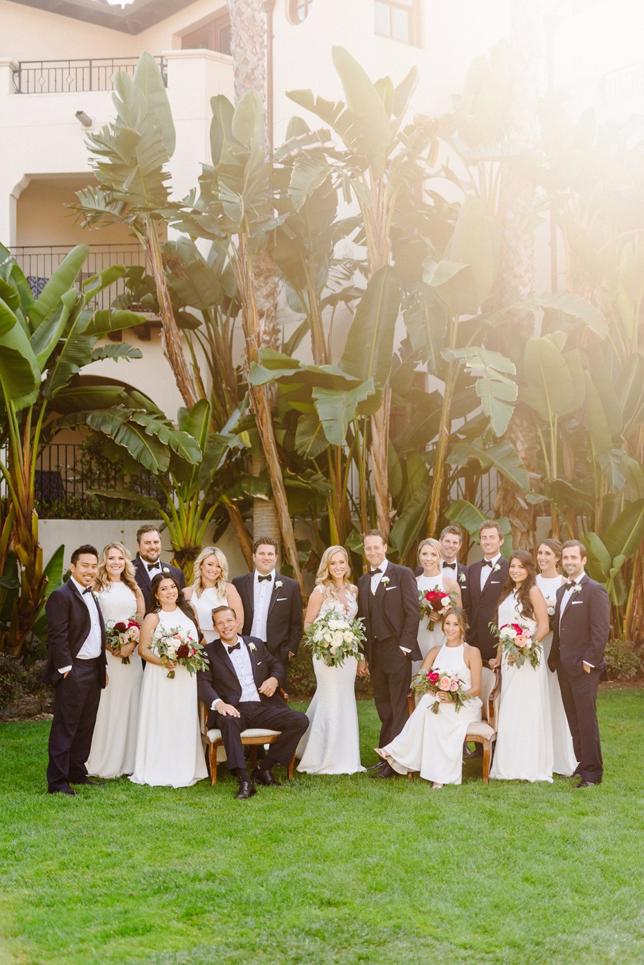 Bridal party poses in garden for a wedding day portrait