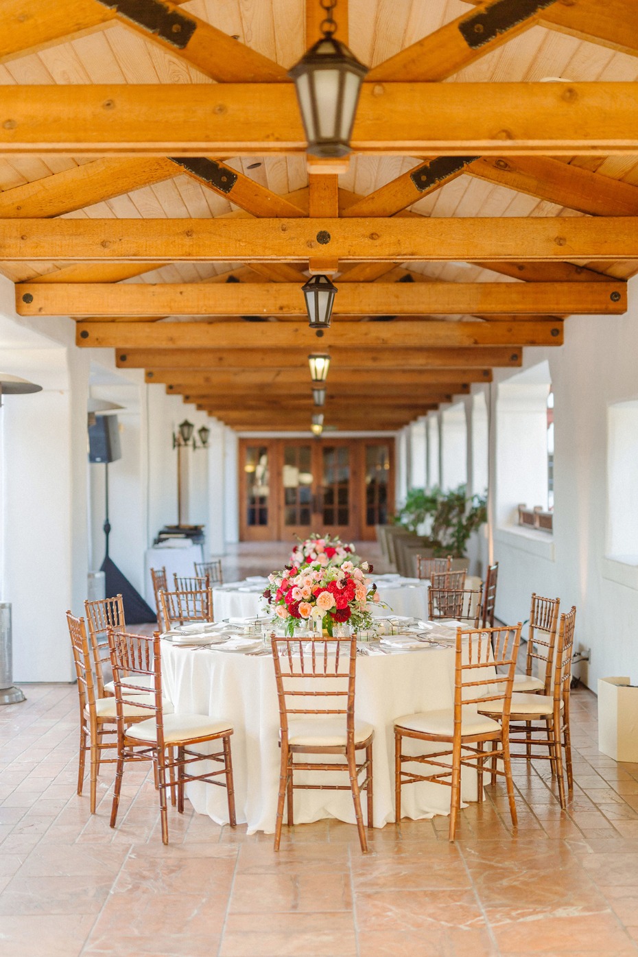 Elegant outdoor wedding reception with table and flower arrangement