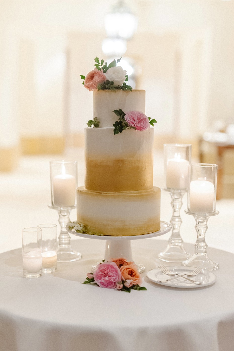Elegant wedding cake with floral decorations and candles