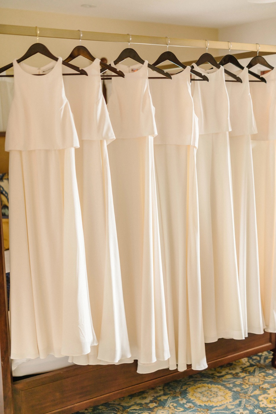 Off-white bridesmaid dresses hang ready for the wedding