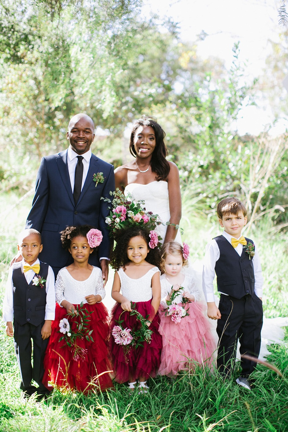 the bride groom and their flower girls and ring bearers
