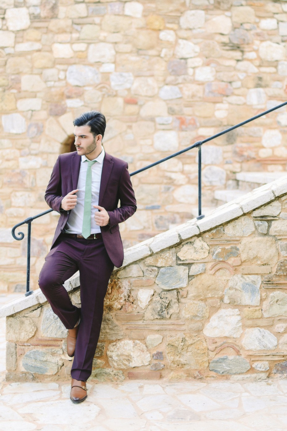 Eggplant colored suit with green tie