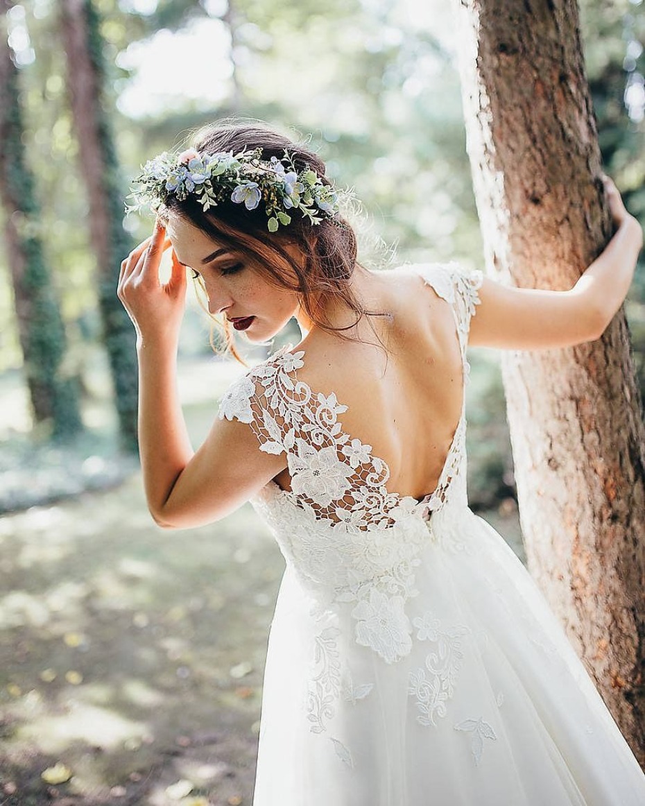 Beautiful bride with flower crown wearing lace wedding dress