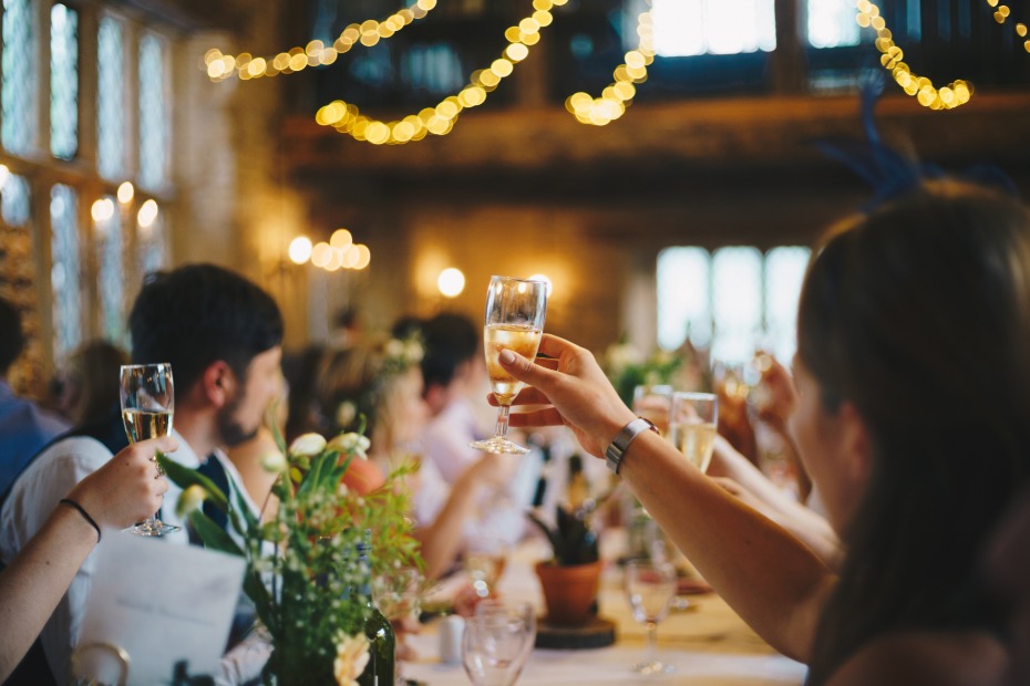 Raising champagne glasses at a wedding reception dinner