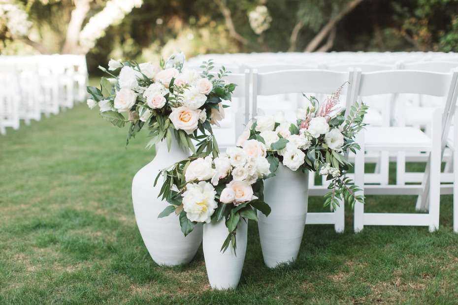 White roses in white vases