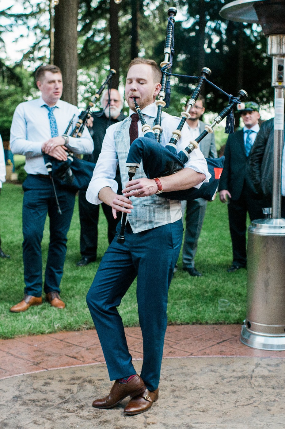 groom playing the bagpipes for his new wife