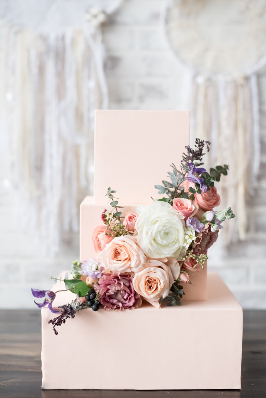 Blush square wedding cake with flowers