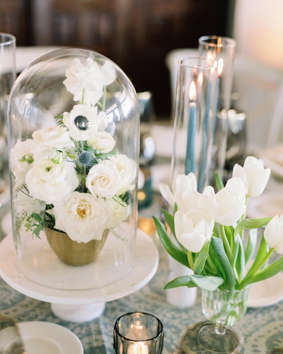 White flowers under glass dome, elegant table decor