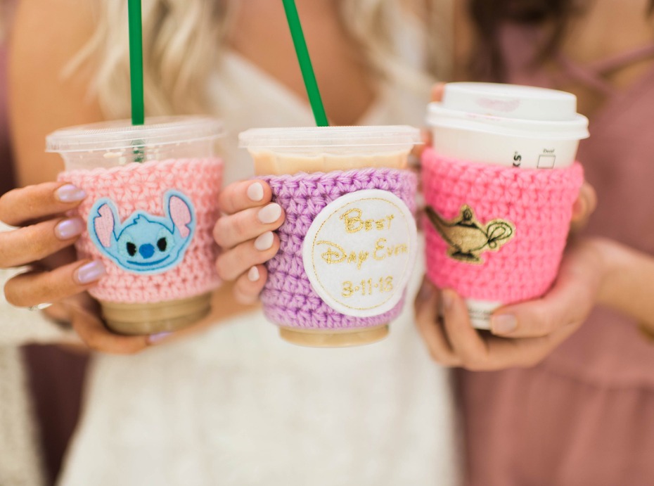 Three crocheted coffee cozies with Disney characters