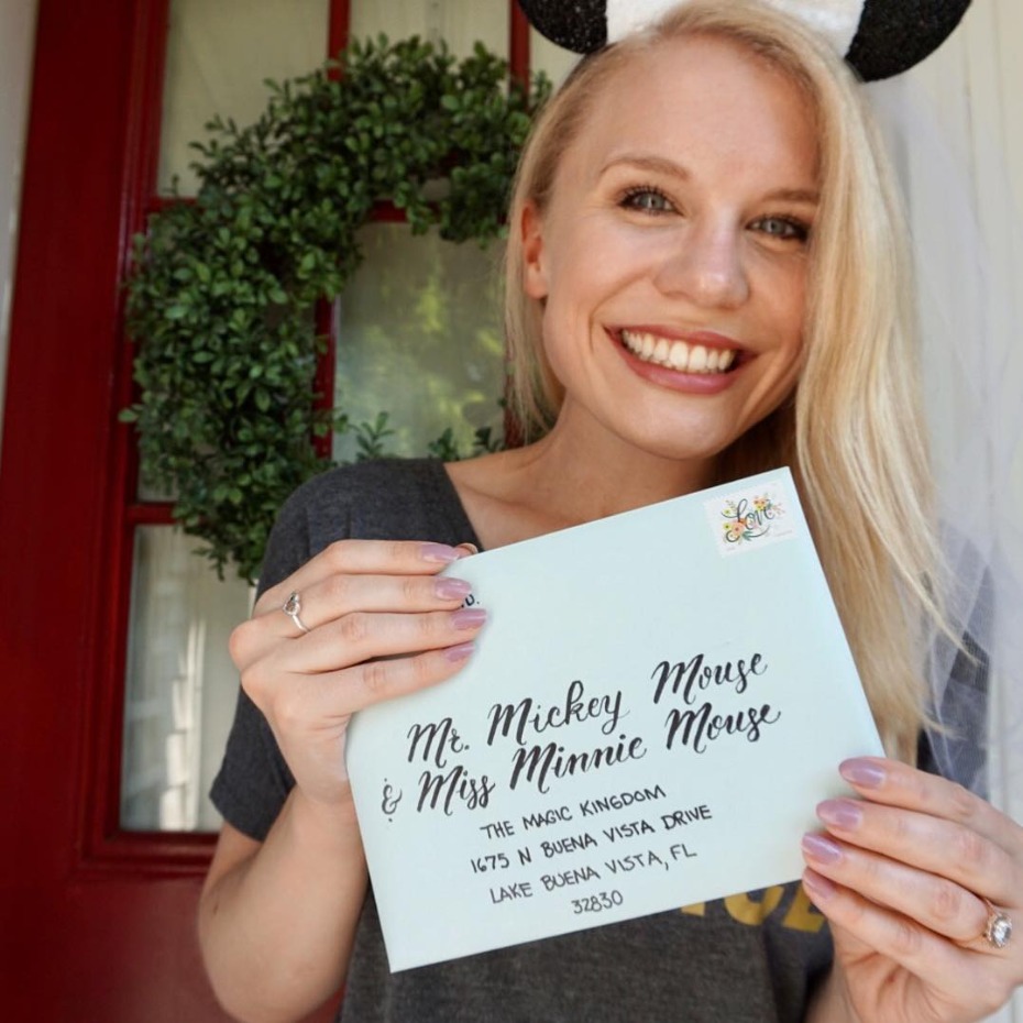 Woman holding letter addressed to Mickey and Minnie Mouse
