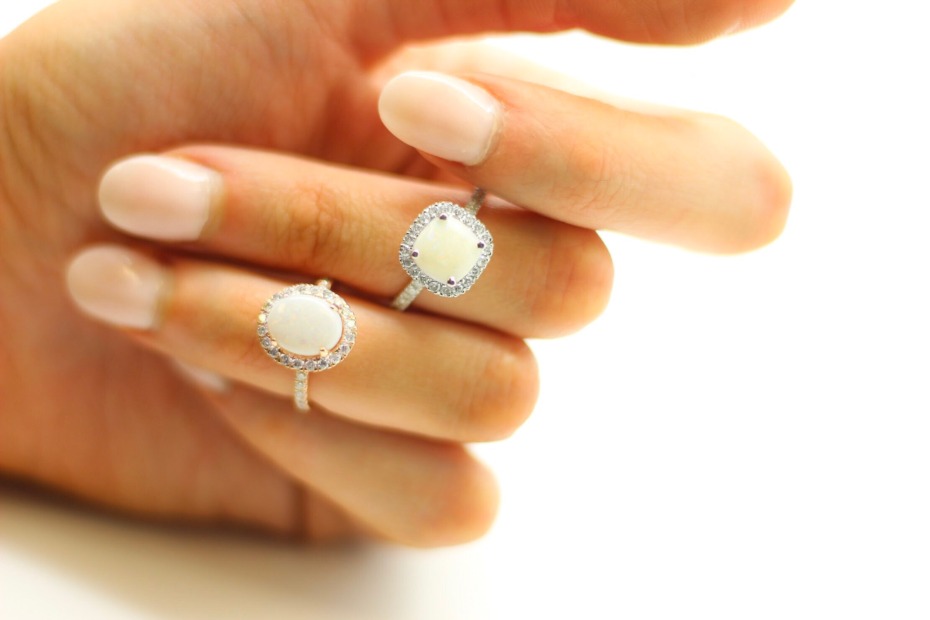 Close-up of two elegant opal rings on a woman's hand