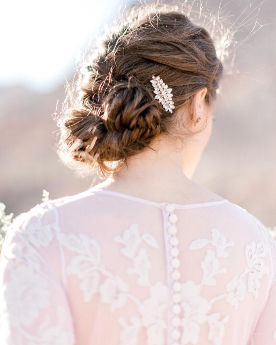 Elegant bridal updo with jeweled hair accessory detail