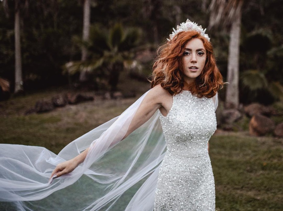 Bride in a sparkly wedding dress and crown outdoors