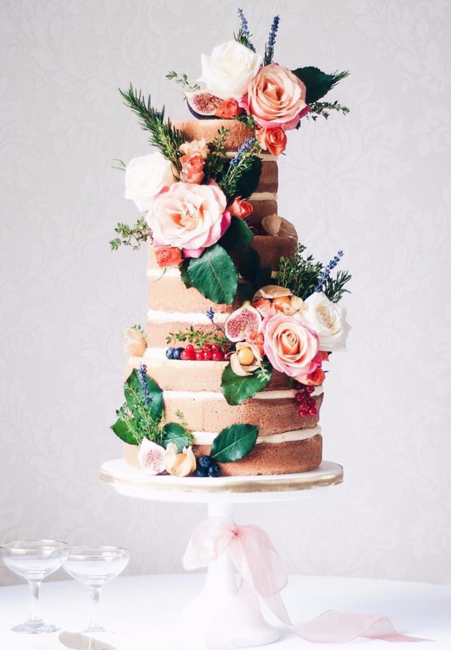 naked wedding cake with flowers and fruit