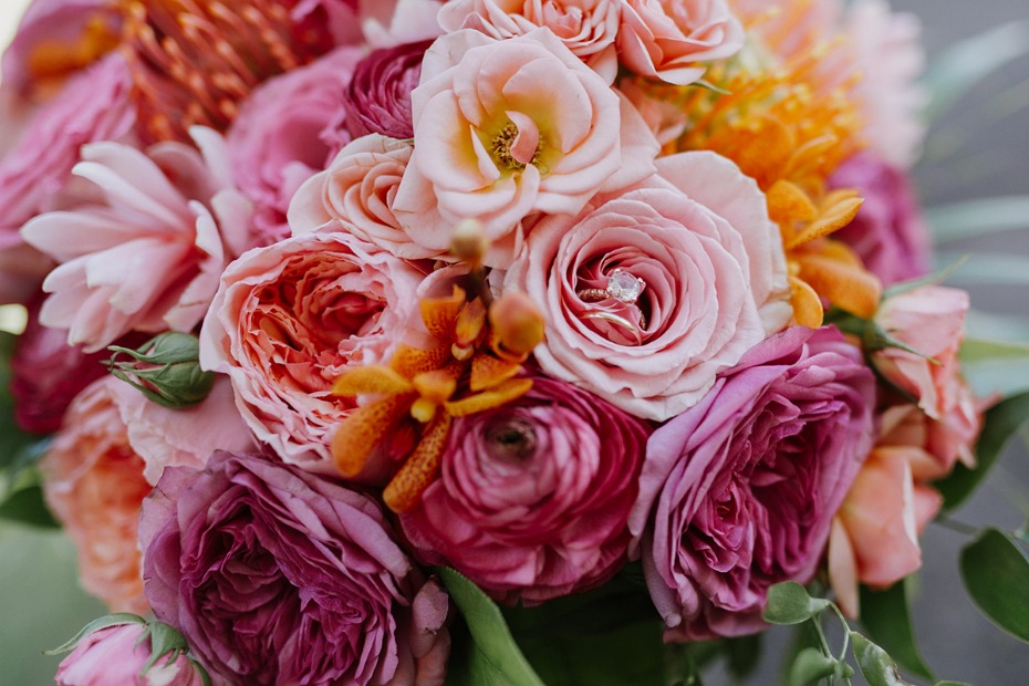 Elegant bouquet of pink roses with a diamond engagement ring