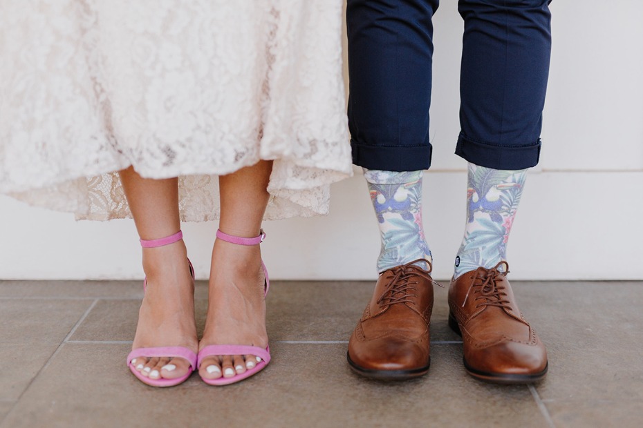 Wedding couple legs and shoes with pink heels and floral socks