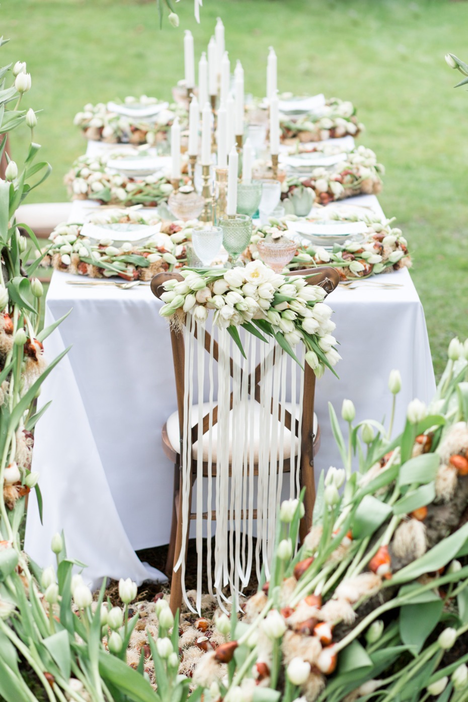 Elegant outdoor table setting with white flowers and candles