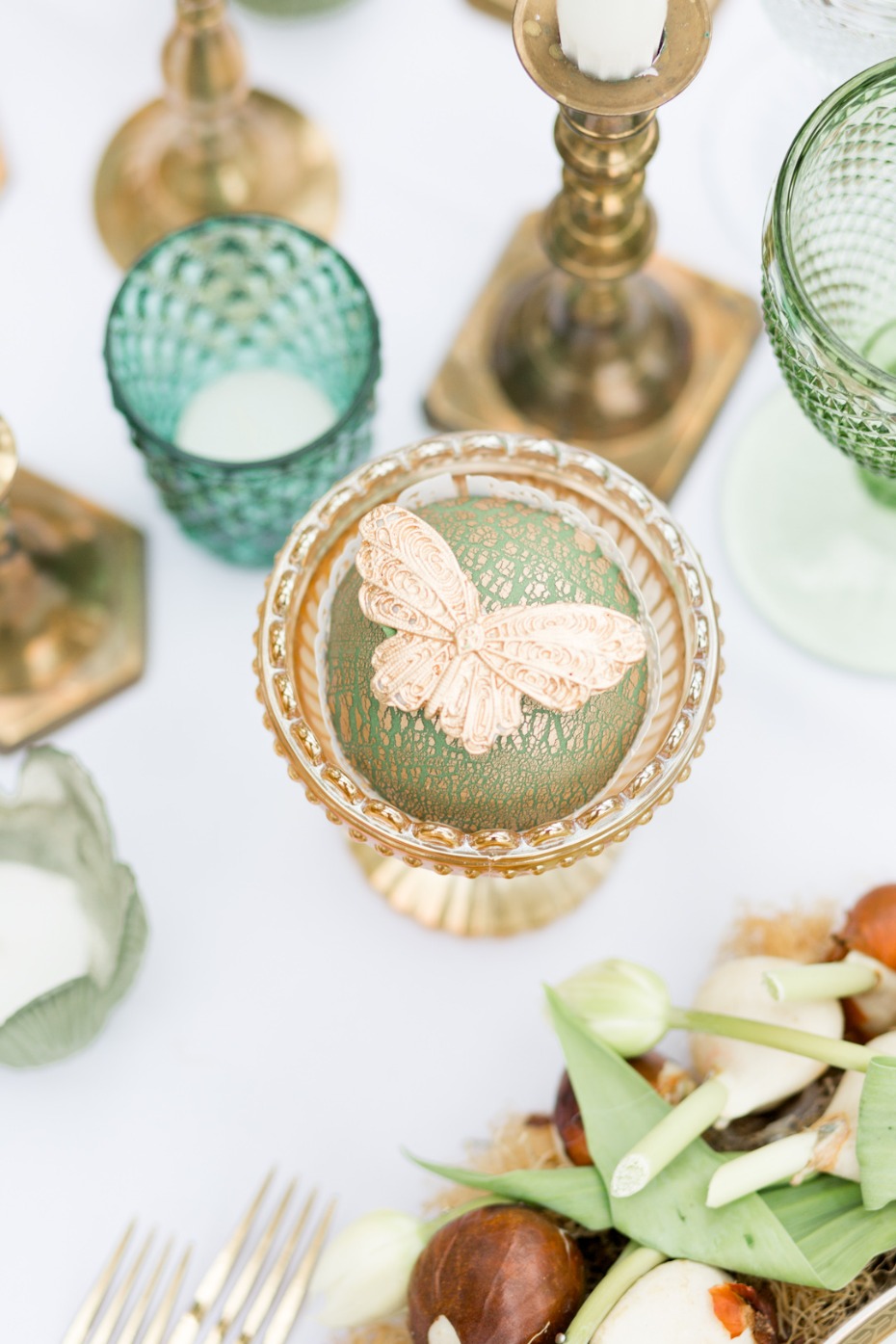 Elegant table setting with gold accents and butterfly decoration