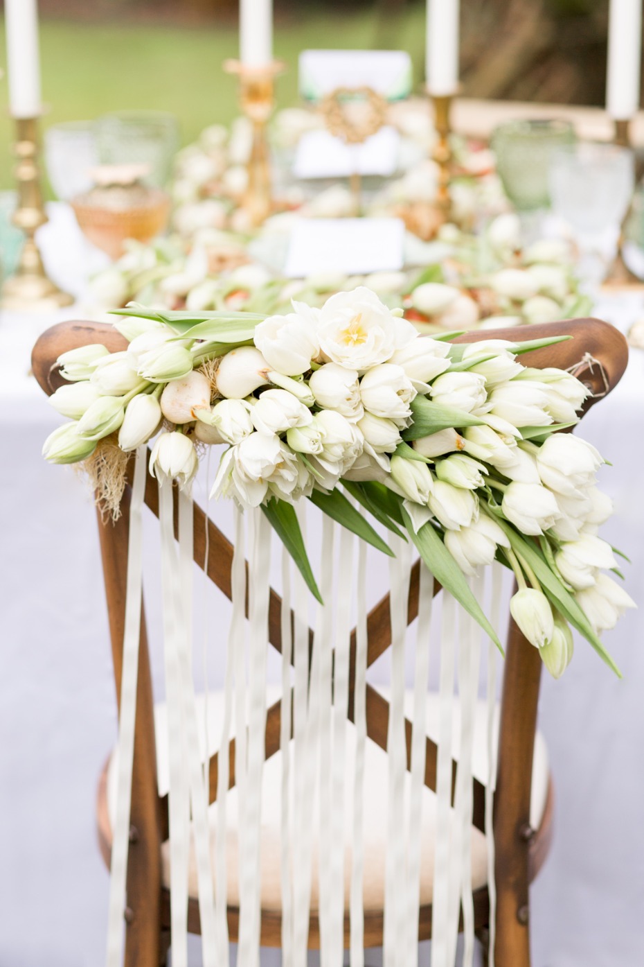 Elegant chair decorated with white tulips for a wedding event