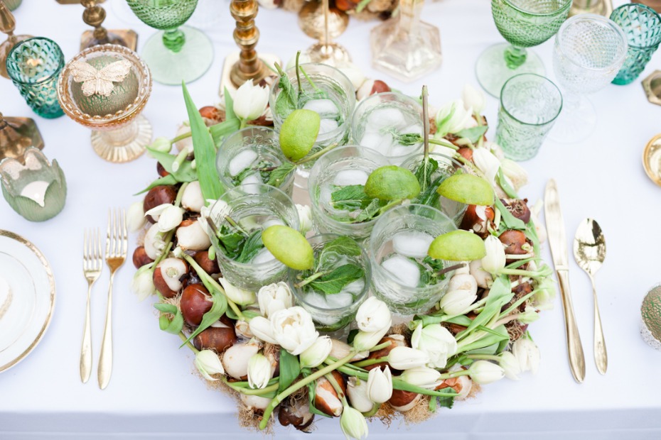 Elegant table setting with cocktails and flower arrangement