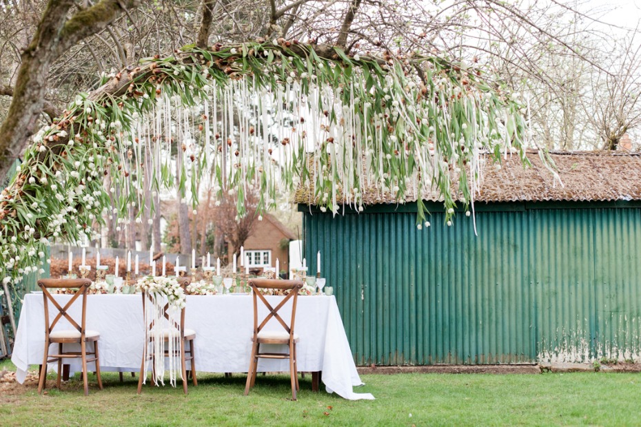 Elegant outdoor wedding decor with floral arch and table