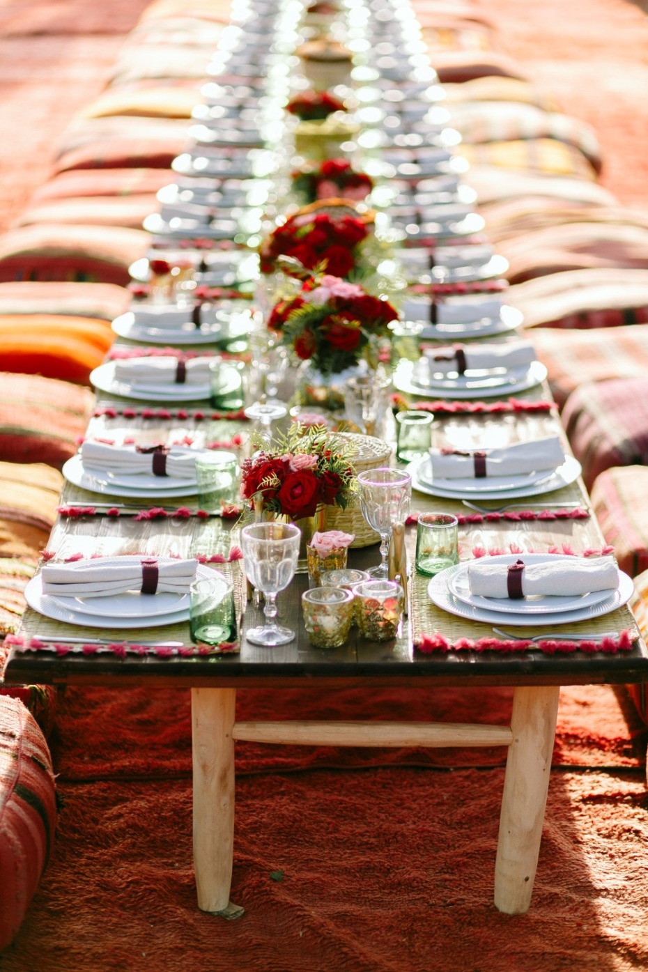 Long wooden table elegantly set for a special outdoor occasion