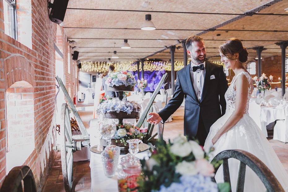 Bride and groom smiling at wedding, beautiful flowers and decoration