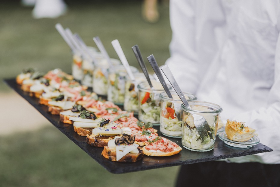 Tray of appetizers including bruschetta and salad jars