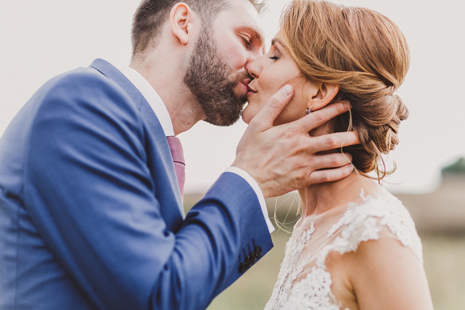 Romantic wedding kiss between bride and groom close up