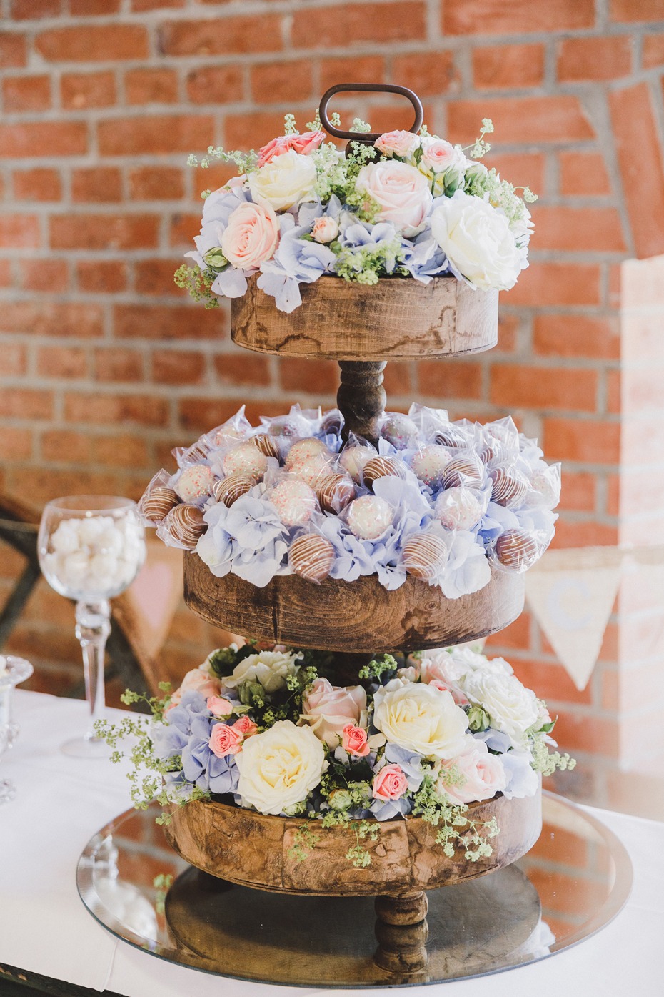Elegant tiered dessert display with flowers at a celebration