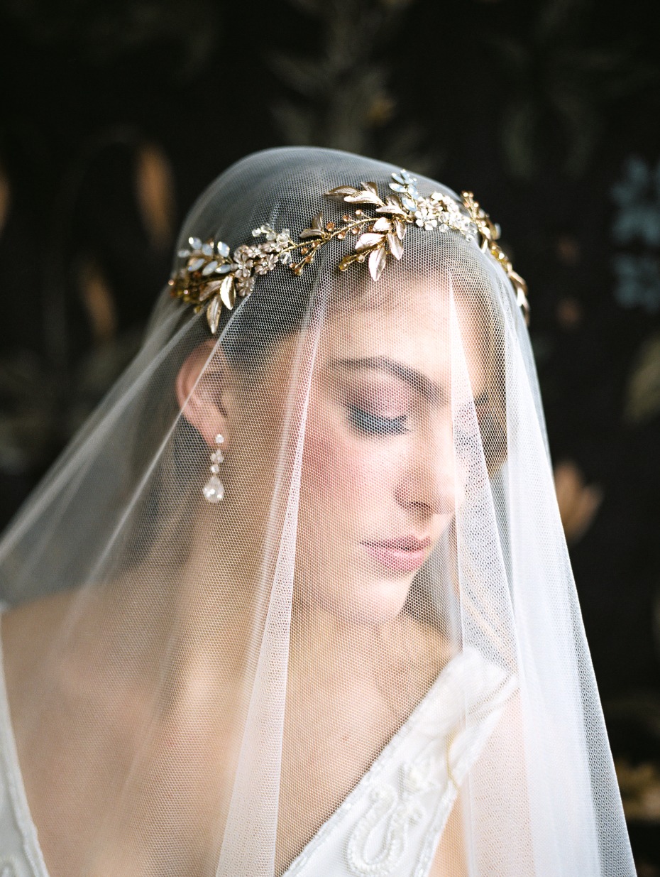 Elegant bride with a gold floral crown and veil