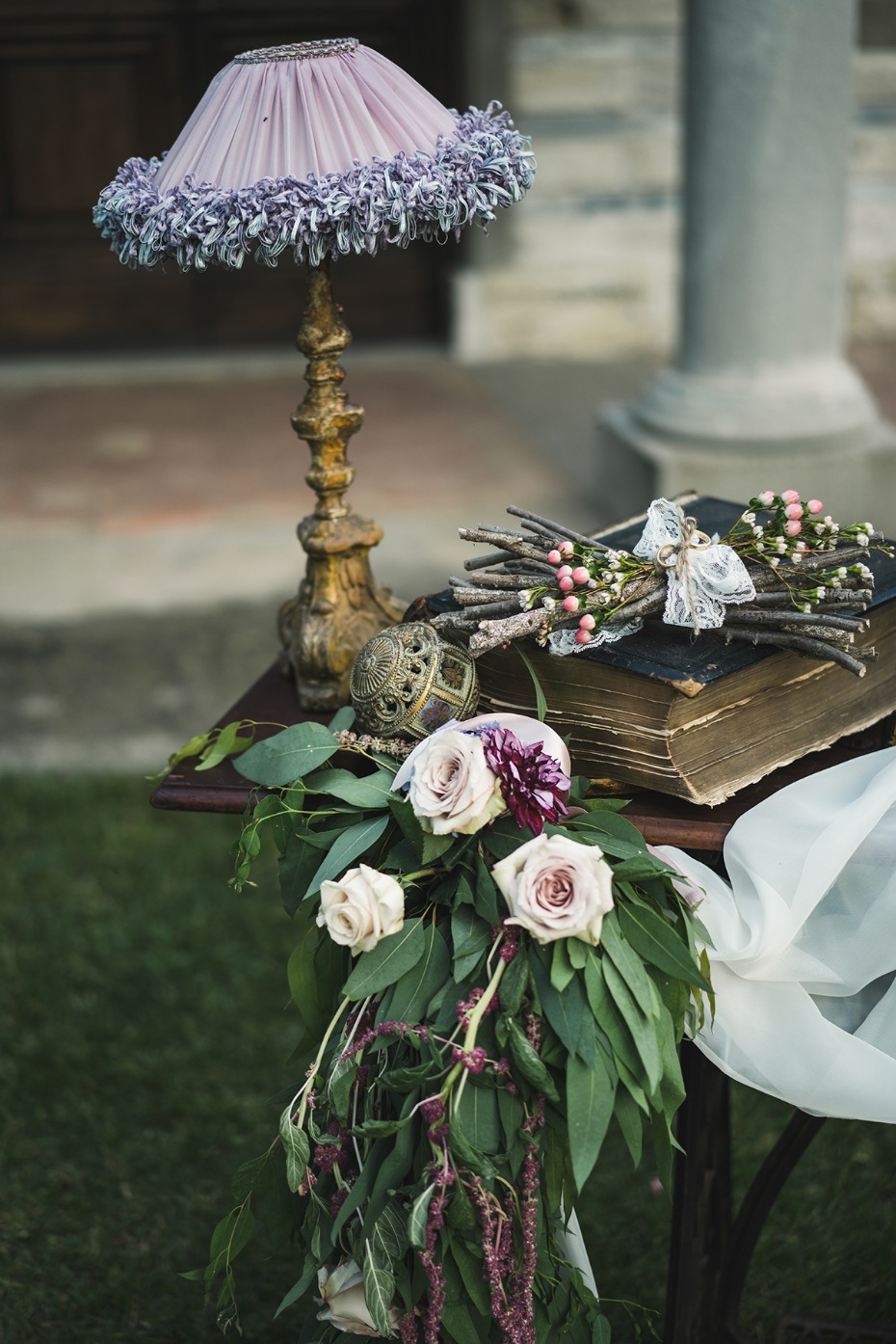 Lavender lamp, flowers, and antique book wedding decor