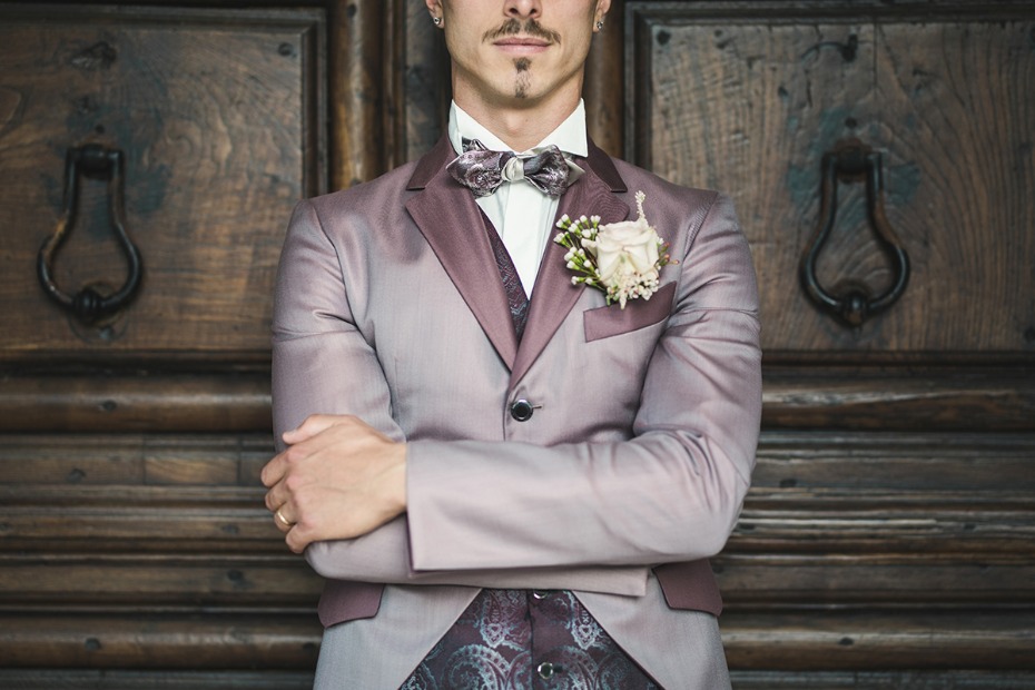 Groom in mauve suit with floral boutonniere detail