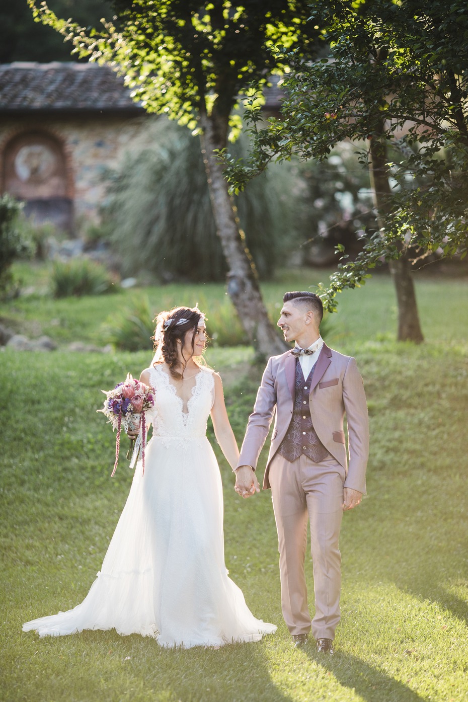 Happy bride and groom walking hand-in-hand