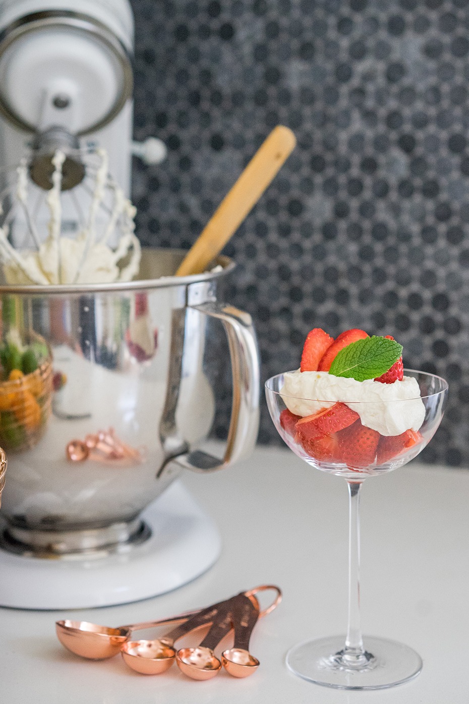 Strawberry dessert with whipped cream and fresh mint in a glass