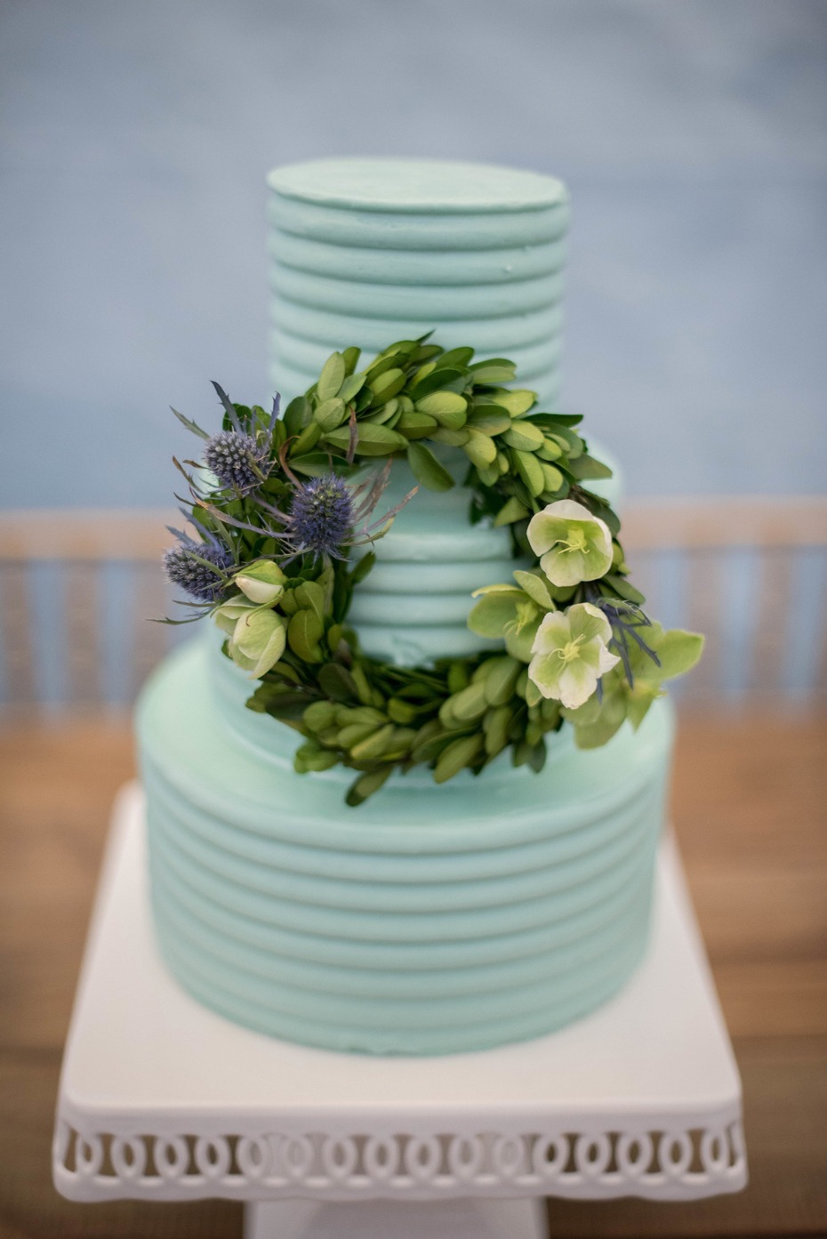teal wedding cake with mini wreath accent