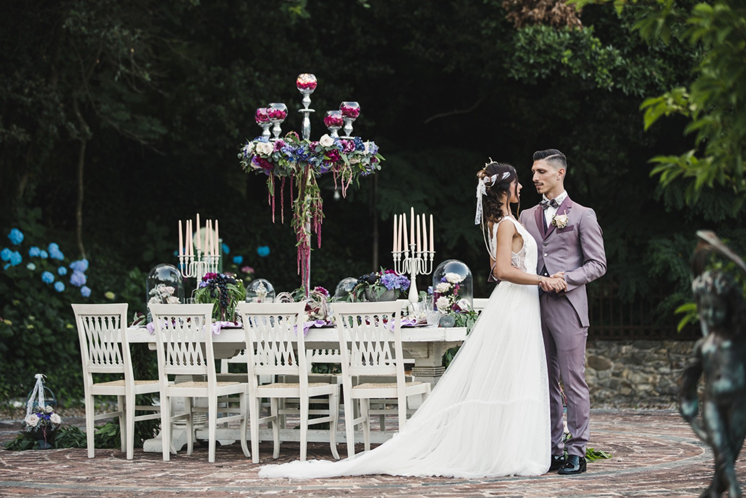 Romantic wedding couple posing by reception table