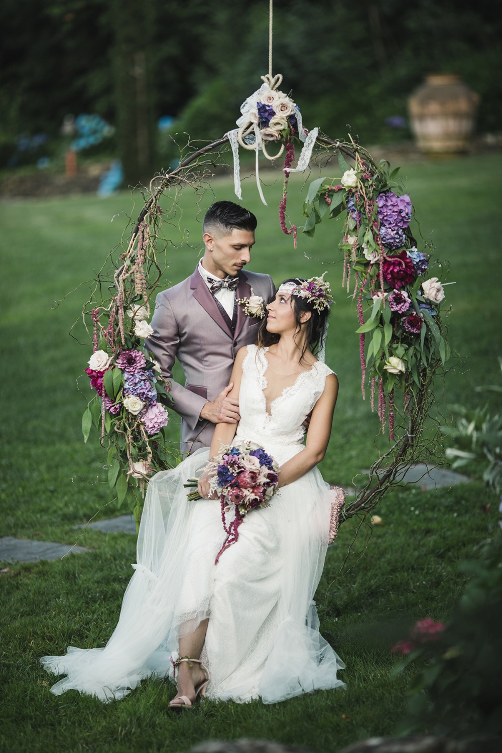 Romantic wedding couple on floral swing