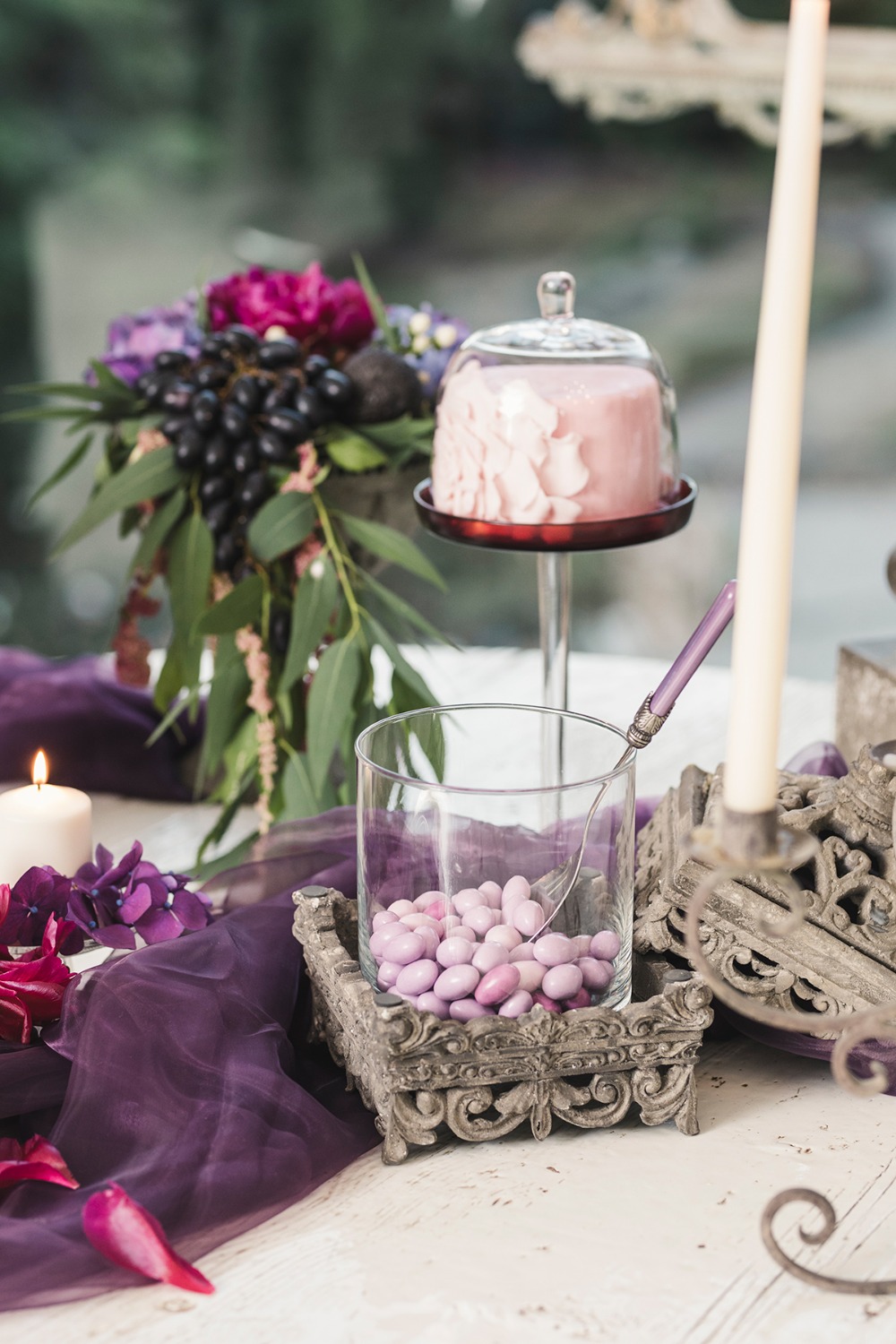Purple candy and pink cake at wedding reception