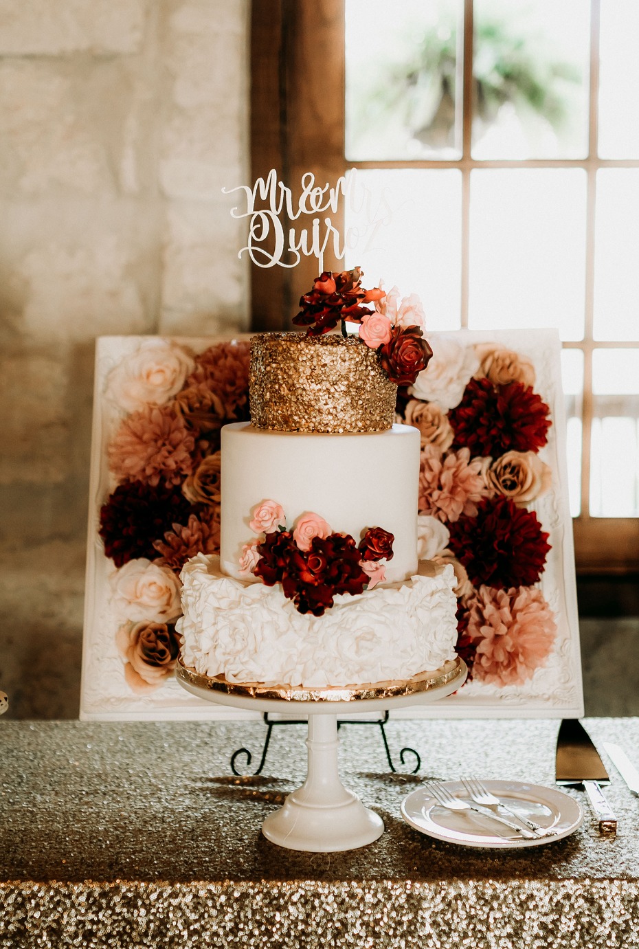 White, gold, and burgundy wedding cake