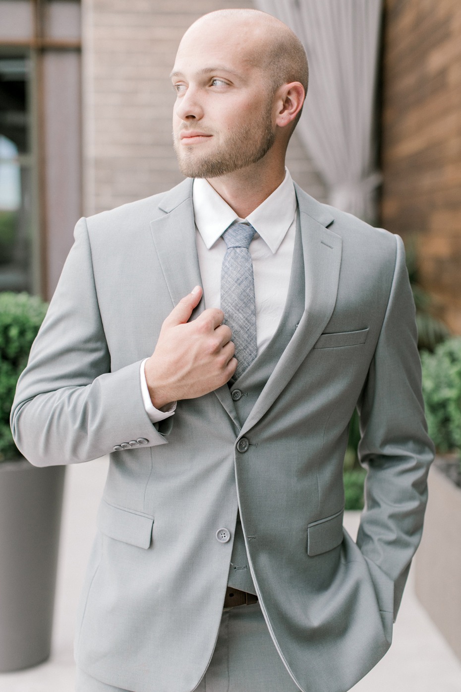 groom in soft grey three piece suit