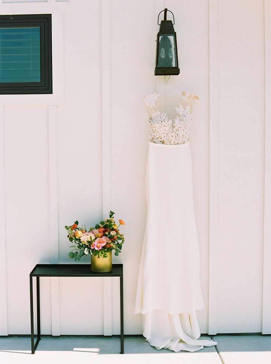 Elegant wedding dress with lace detail and flower arrangement