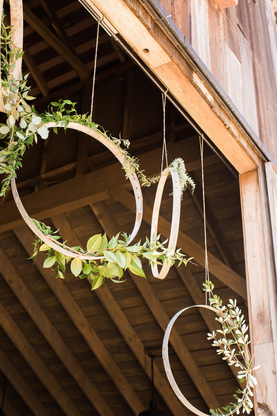 Hanging floral hoop decorations in a rustic barn venue