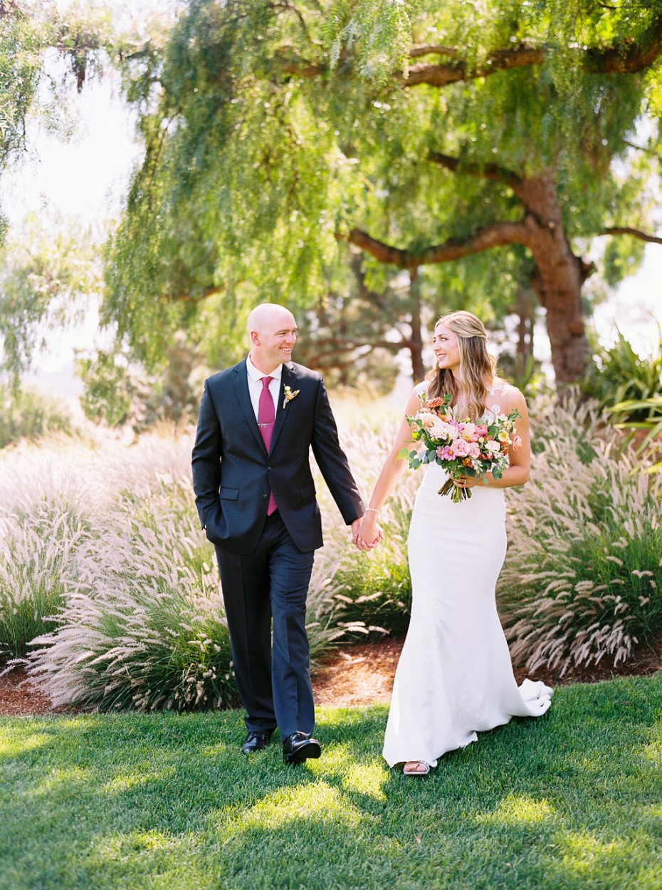 Happy couple walking hand in hand on their wedding day