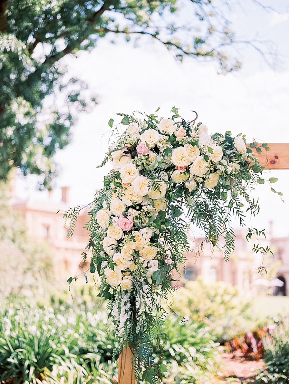 Elegant floral arrangement on wooden wedding arch outdoor