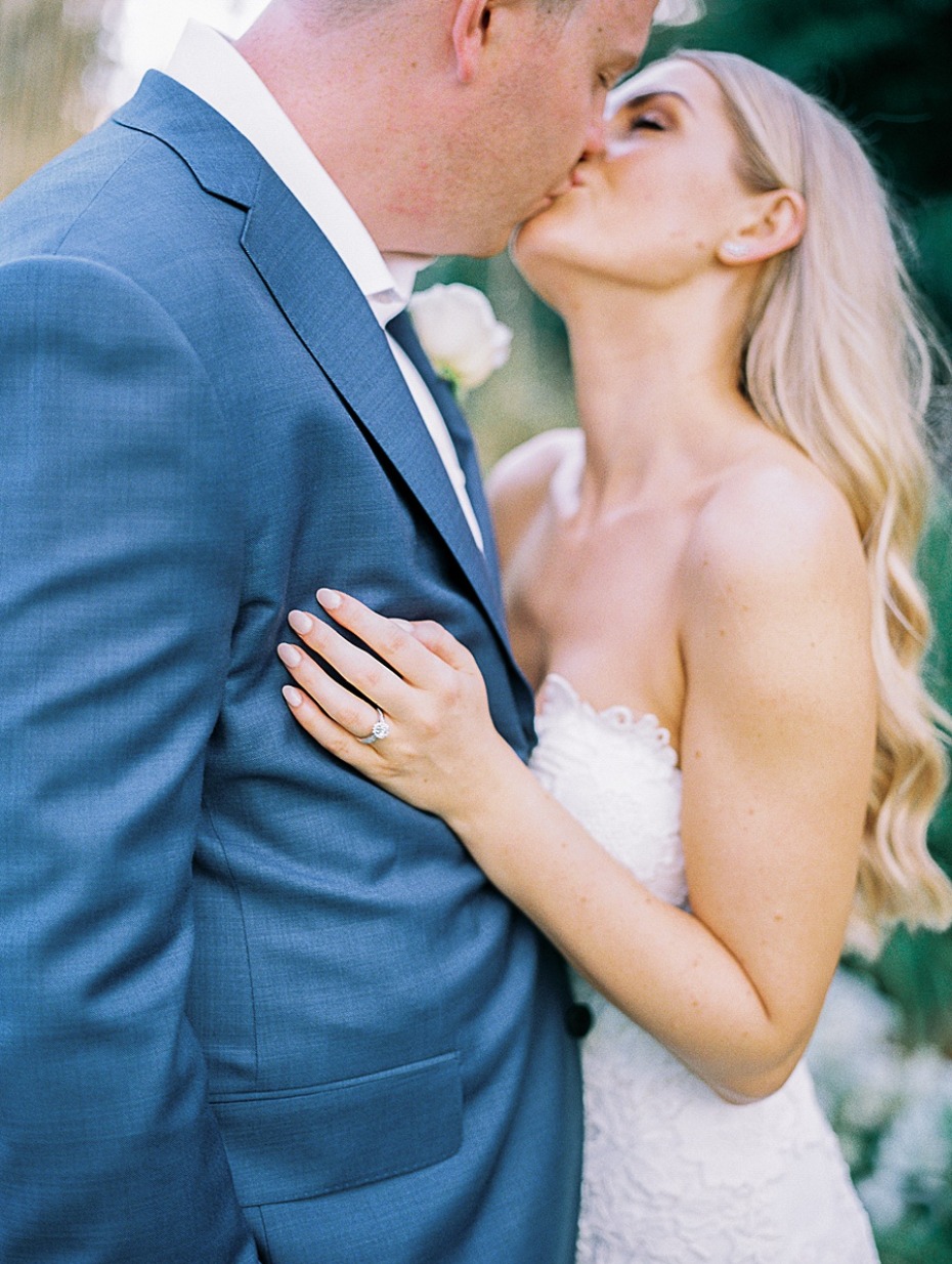 A loving couple shares a tender kiss on their wedding day