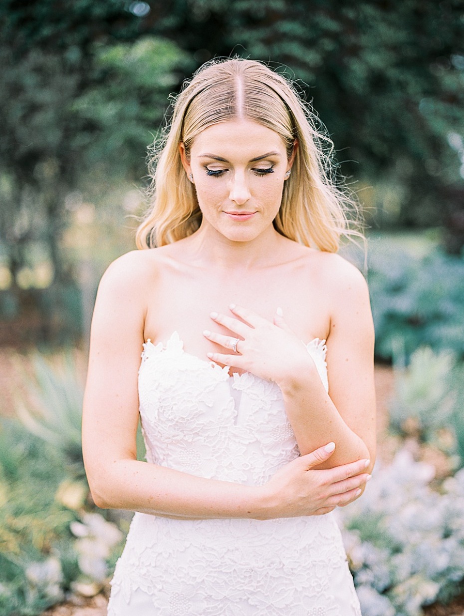 Elegant bride in white lace wedding dress in a garden