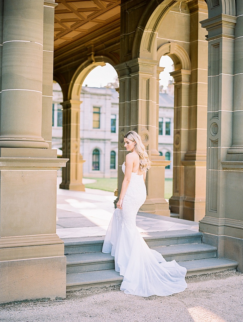 Elegant bride in a white dress posing for photos outdoors