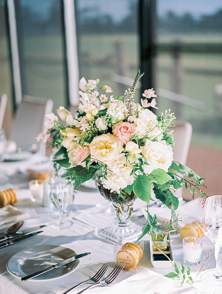 Elegant floral centerpiece at a wedding reception table setting