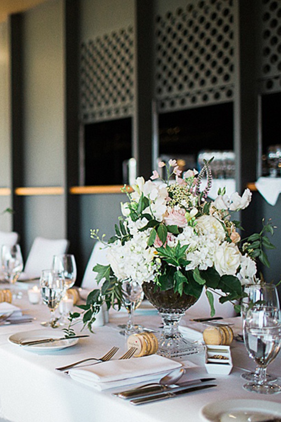 Elegant wedding reception table setting with floral centerpiece